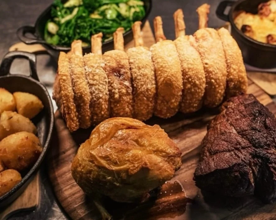 Traditional Sunday roast with crispy pork and vegetables at Downham Hall