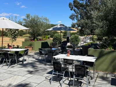 Outdoor terrace dining area at countryside restaurant in Essex with garden views